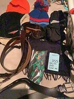 Group shot showing belts, goggles, hats, gloves, scarf and packaged tie