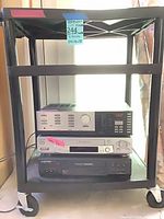 Full view of cart with three electronics stacked on shelves