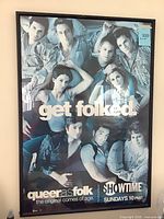 Full view of framed Queer as Folk poster showing size and frame