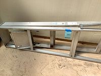 Full view of ladder retracted showing rails and rungs