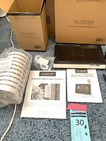 All components laid out with box, base display, sensor shield, manuals, adapter