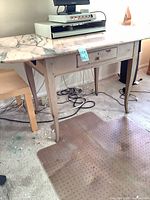 Full view of desk showing wood frame, marble top, single drawer, tapered legs