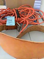Weight belt coiled with orange extension cord