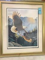 Full view of framed lithograph with gold tone frame and mats