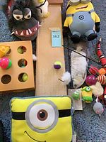 Overview showing plush toys, scratch board, ball maze, assorted cat toys