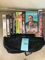 Top view of all nine VHS tapes showing spines and cover art for identification