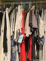 Closet view showing numerous hung T-shirts in assorted colors
