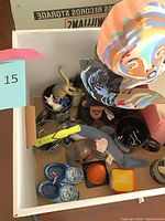 Box overview showing figurine, mugs, plush, small toys and novelties