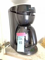 Full view of coffee maker showing brand and overall condition