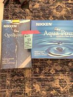 Front view of two boxed Nikken PiMag units: Optimizer II and Aqua Pour
