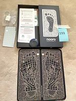 Complete set in box: mat folded, controller, charger, manuals, electrode pads