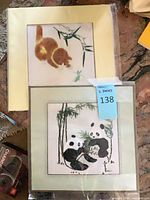 Both framed embroidery pieces in protective wrap showing panda and kitten subjects