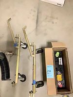 Battery in box, two wheel dollies, coiled hose with blow gun
