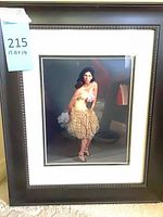 Full view of framed signed photograph showing frame, mat, and image