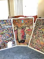 All three framed prints standing side by side showing designs and white frames
