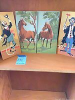 All four unframed panels on shelf
