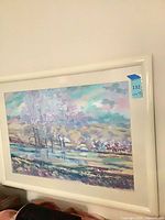 Full framed painting on wall showing artwork and white frame