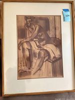 Full view of framed artwork showing figure, mat, and wood frame