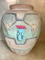 Full view of large Southwestern vase showing bull skull relief and geometric design
