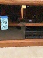 Front view of stand showing glass doors, Arris box and Quasar VHS