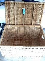 Open wicker trunk showing interior and lid