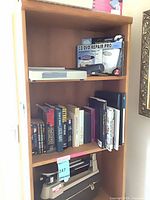 front view showing upper shelves with peg holes and contents (contents not included)