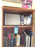 Shelf with paper cutter board, CD/DVD Repair Pro box, books