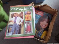 Stitch by Stitch magazine on top of box alongside Woman's World issues