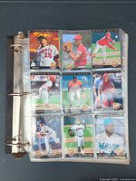 Binder open showing nine different Upper Deck baseball cards in sleeves