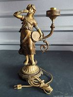 Full view of figural table lamp with cord and socket