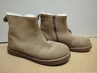 Both boots side view showing suede upper and faux fur lining