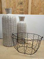 Group view of both wicker vases and metal basket