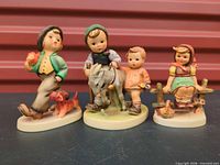All three Hummel figurines side by side