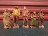 Front view of five hand-carved wooden folk figurines