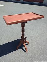 Full view of painted pedestal side table outdoors