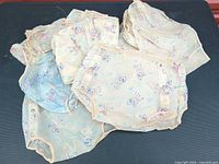 pile of vinyl diaper covers showing color variations and deer pattern