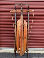Full view of vintage Lightning Cruiser sled upright against wall