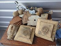 Full group of assorted wood architectural salvage on tabletop