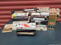 Overall stack of mixed VHS tapes on table