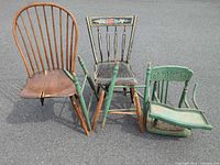 All three damaged chairs standing and lying on pavement