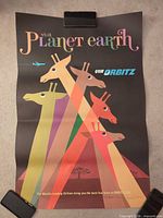 Full view of rolled poster held by clips showing entire design and fold lines