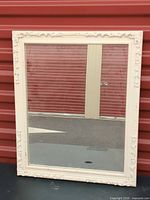 Full view of rectangular ornate white mirror