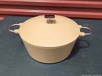 Dutch oven with lid closed showing exterior color and handles