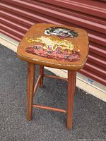 Full view of stool showing painted seat and legs