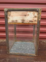 Full view of cabinet showing galvanized frame, glass panels and front sign
