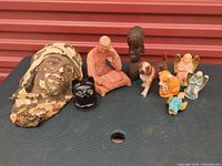 Group shot of all nine figurines and sculptures