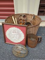 Group shot of all items: basket, framed doily, metal kitchenware