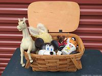 Overall view of open woven basket with assorted toys inside