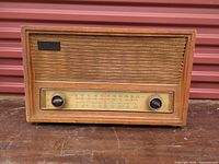 Front view showing speaker cloth, tuning scale, knobs