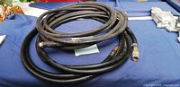 Coiled pair of black air hoses showing overall appearance